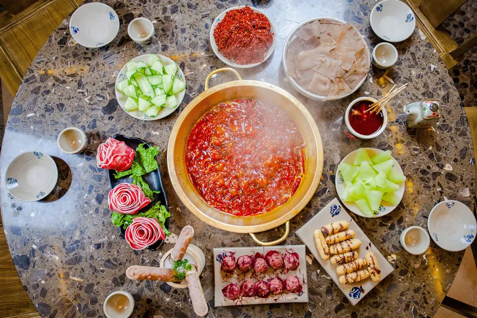 Sichuan hotpot with broth, meat, vegetables and dipping sauces